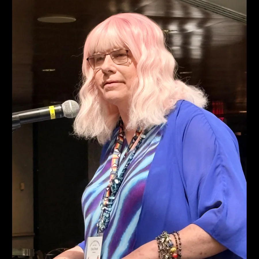 Erika X. Driscoll speaking at a microphone